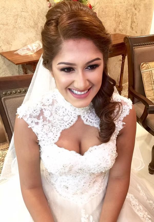 Bride in white lace gown and veil, soft romantic makeup
