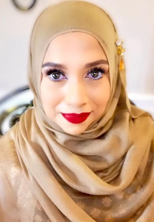 Nikah bridal makeup with hijab styling and bold red lip